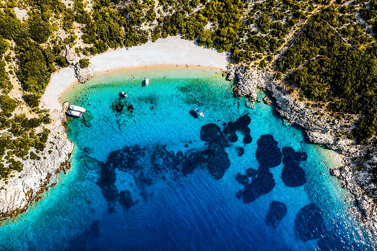 Aerial view of a secluded turquoise bay on the island of Vis