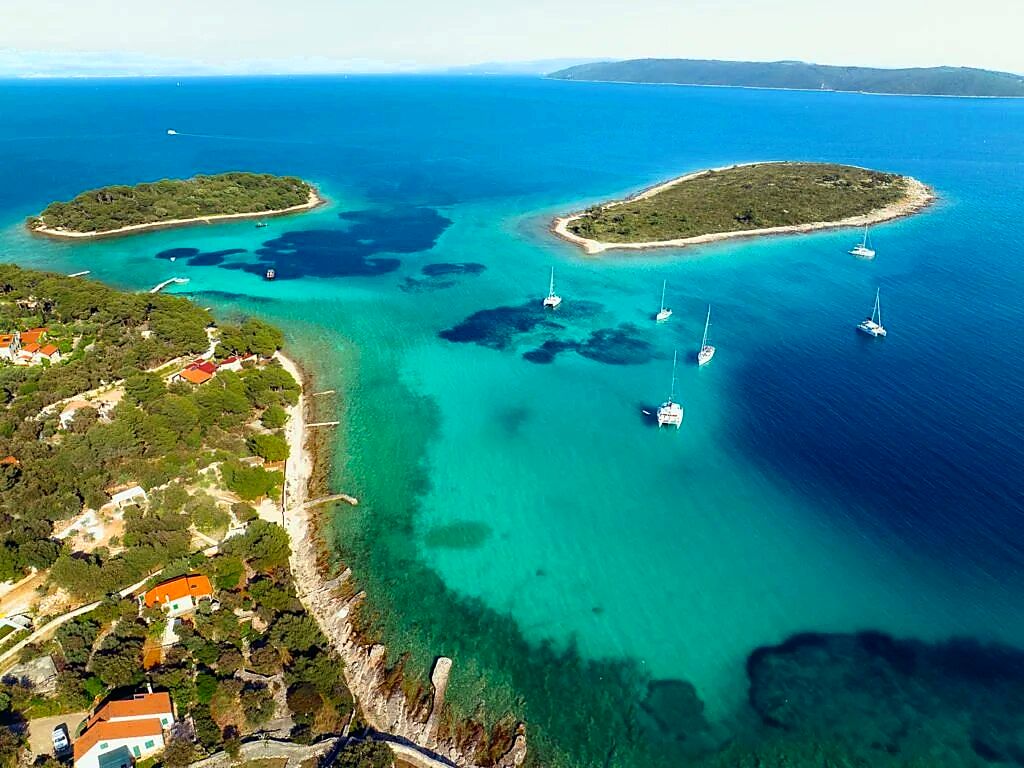 Blue Lagoon near Vis with islands and sailboats from above