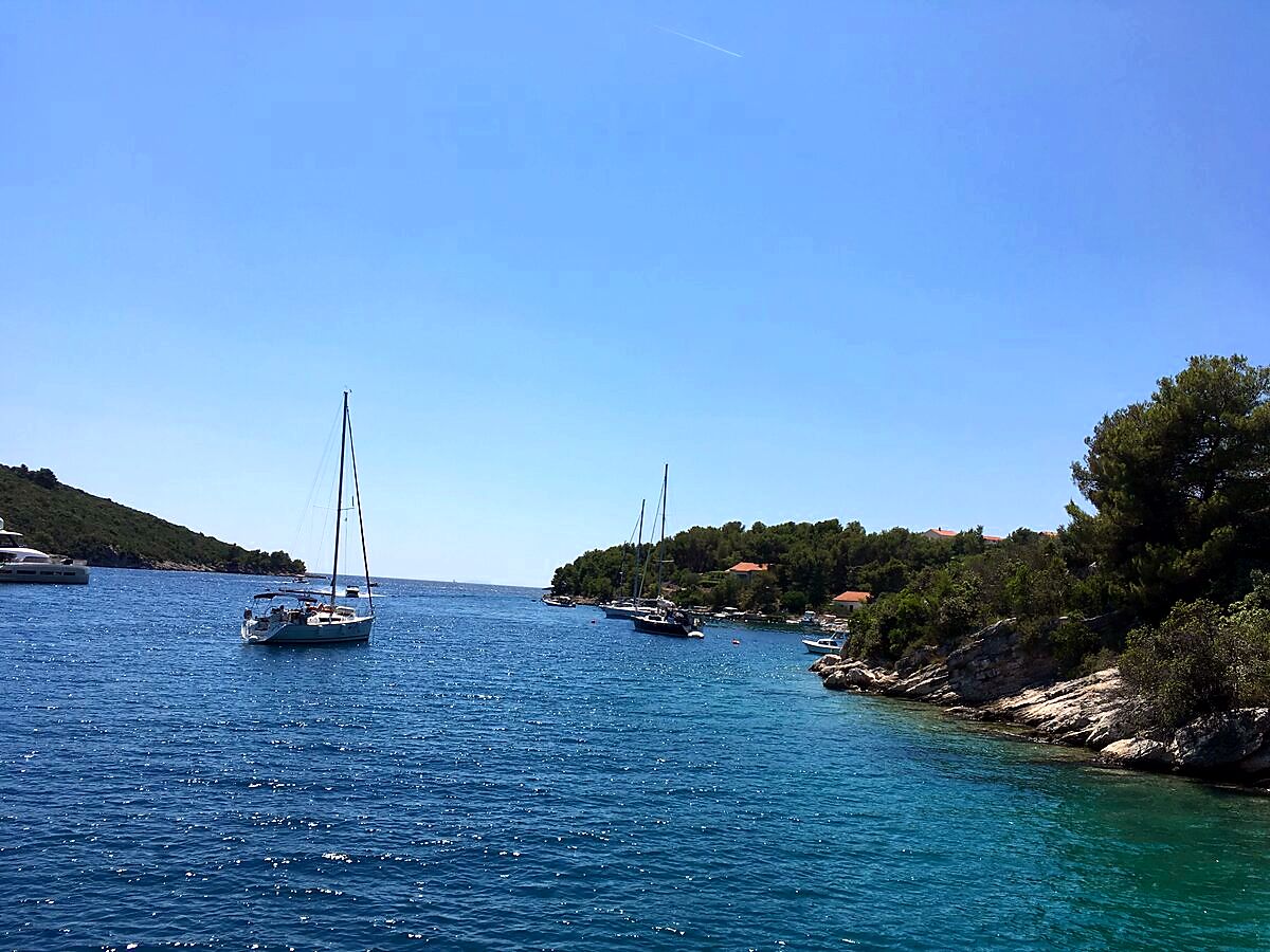 Sailboats anchored in a sheltered bay on Šolta island