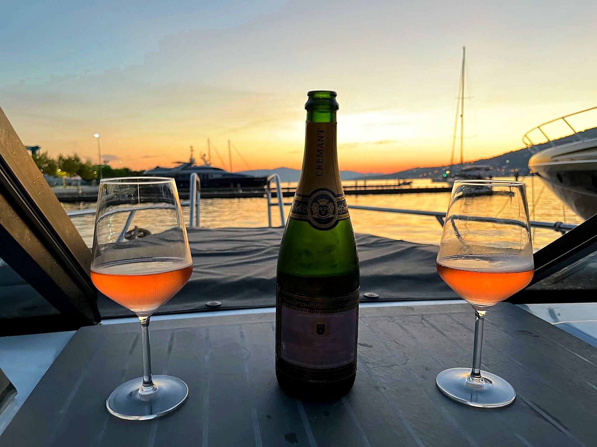 Crémant and glasses on the boat at sunset